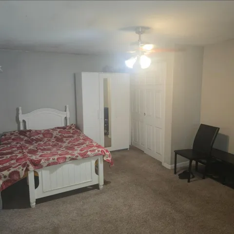 a bedroom with a bed and a chair
