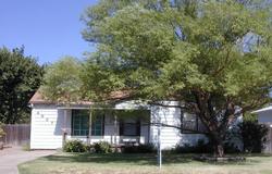 4009 South Travis Street Amarillo, TX 79110 - Photo 1 of 1 a front view of a house with a garden