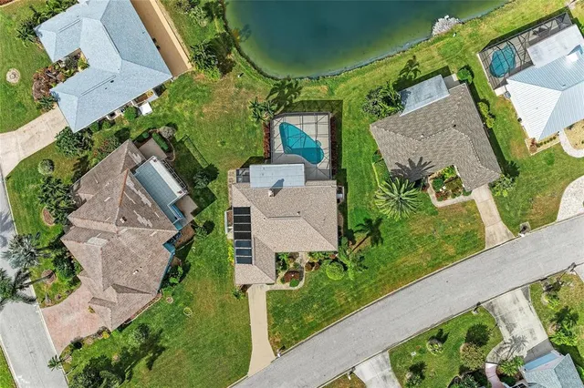an aerial view of a house with garden space and street view