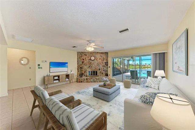 a living room with furniture fireplace and a large window