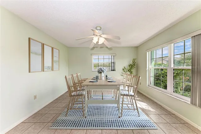 a dining room with furniture a rug and a chandelier