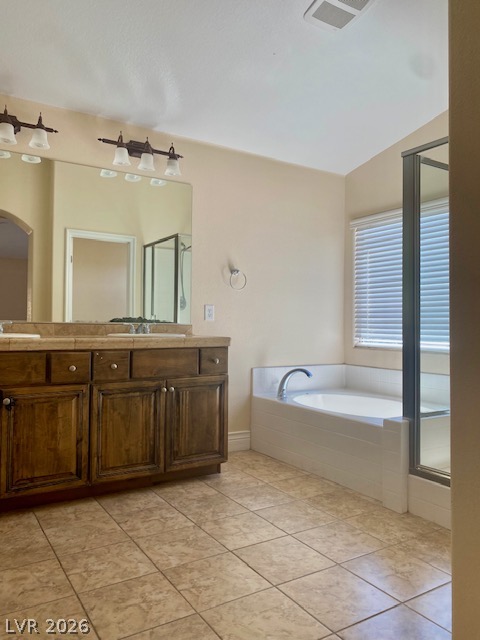 159 Tall Ruff Drive Las Vegas, NV 89148 - Photo 17 of 31 Tile flooring and a deep soaking tub anchor this spacious bathroom layout.