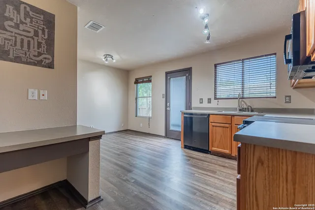 a kitchen with stainless steel appliances granite countertop a stove a sink and a refrigerator