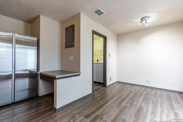 an empty room with wooden floor sink and closet