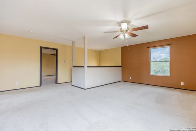 an empty room with windows and cabinet