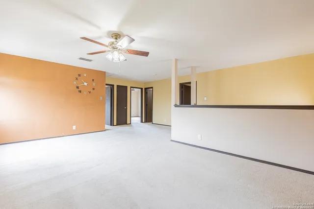 a view of a livingroom with a ceiling fan and window