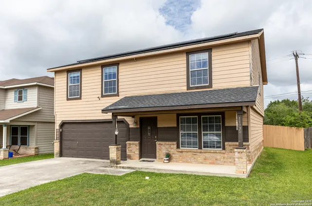 a view of a house with a yard and sitting area