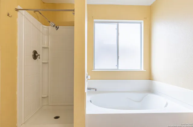 a bathroom with a bathtub and shower