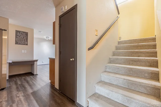 a view of entryway and hall with wooden floor