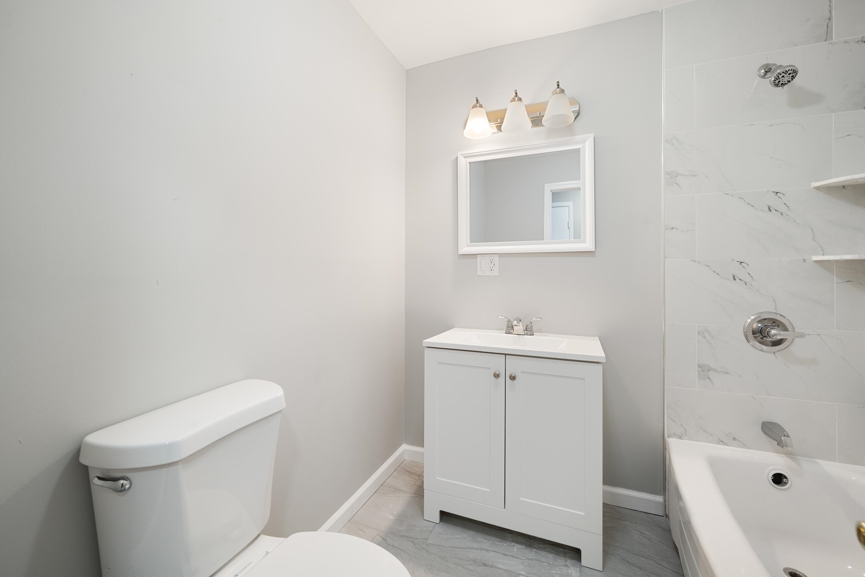 14 Delmar Road Jersey City, NJ 07305 - Photo 13 of 38 a bathroom with a sink a toilet and bathtub
