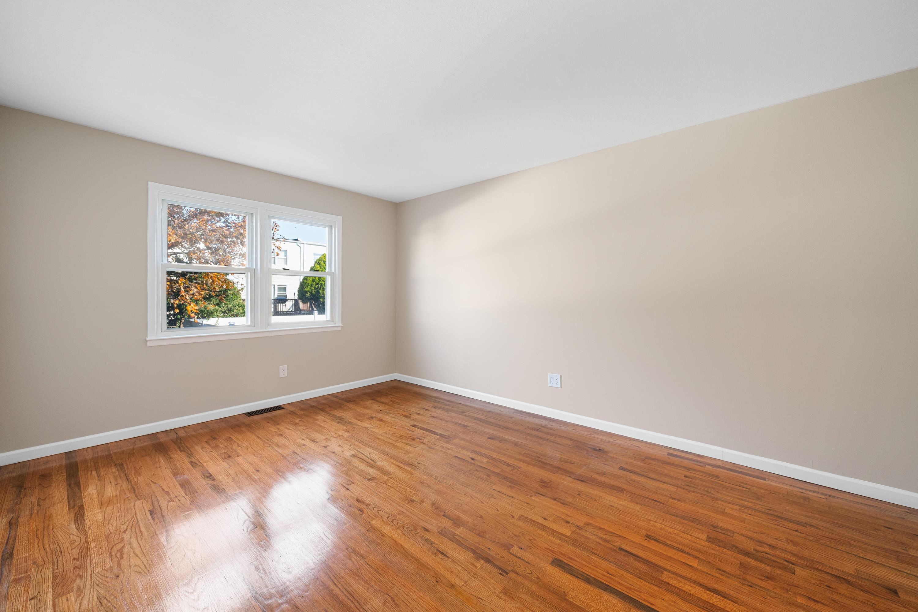 14 Delmar Road Jersey City, NJ 07305 - Photo 15 of 38 an empty room with wooden floor and window