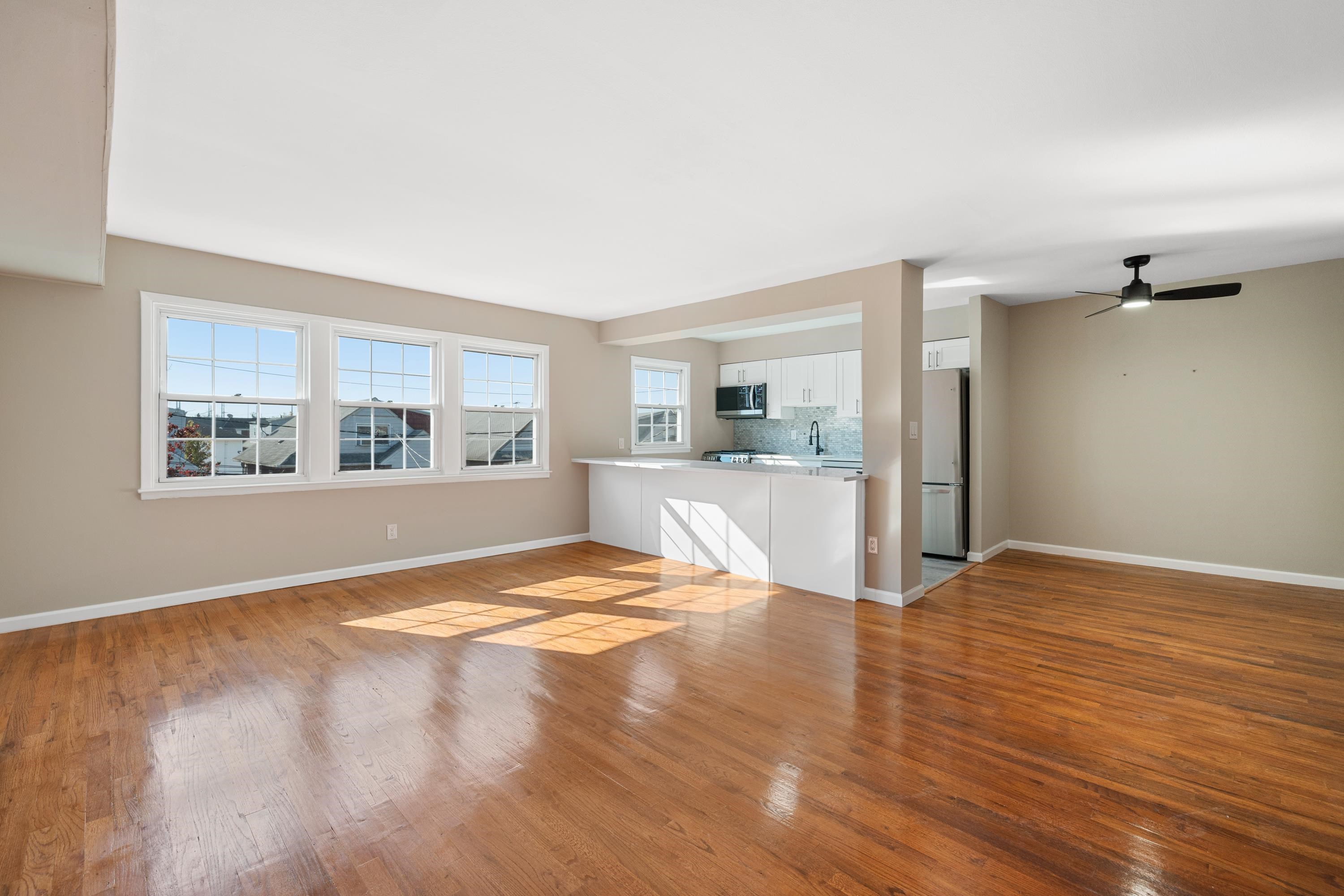 14 Delmar Road Jersey City, NJ 07305 - Photo 24 of 38 a view of an empty room with a window and wooden floor