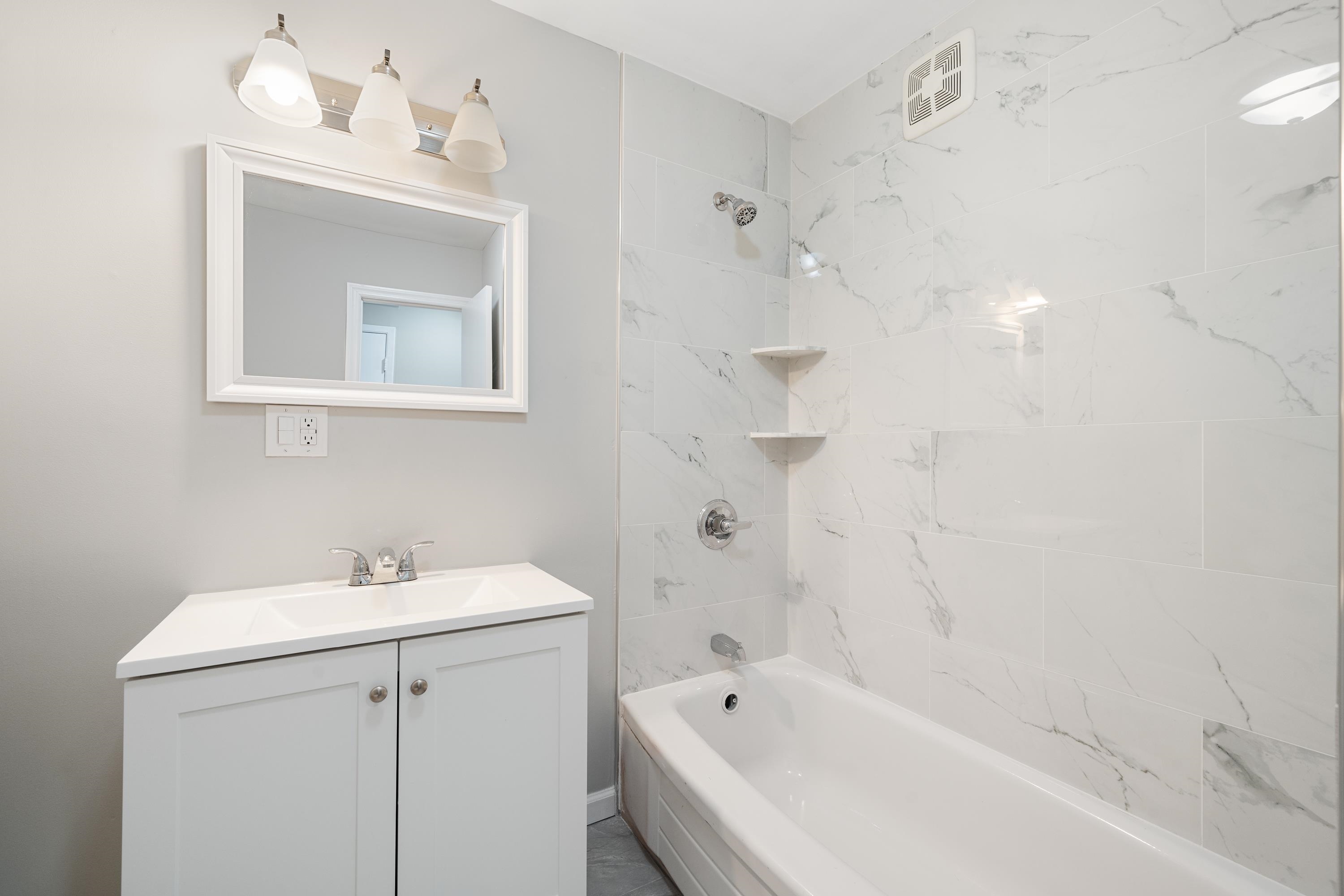 14 Delmar Road Jersey City, NJ 07305 - Photo 27 of 38 a white bath tub sitting next to a white sink