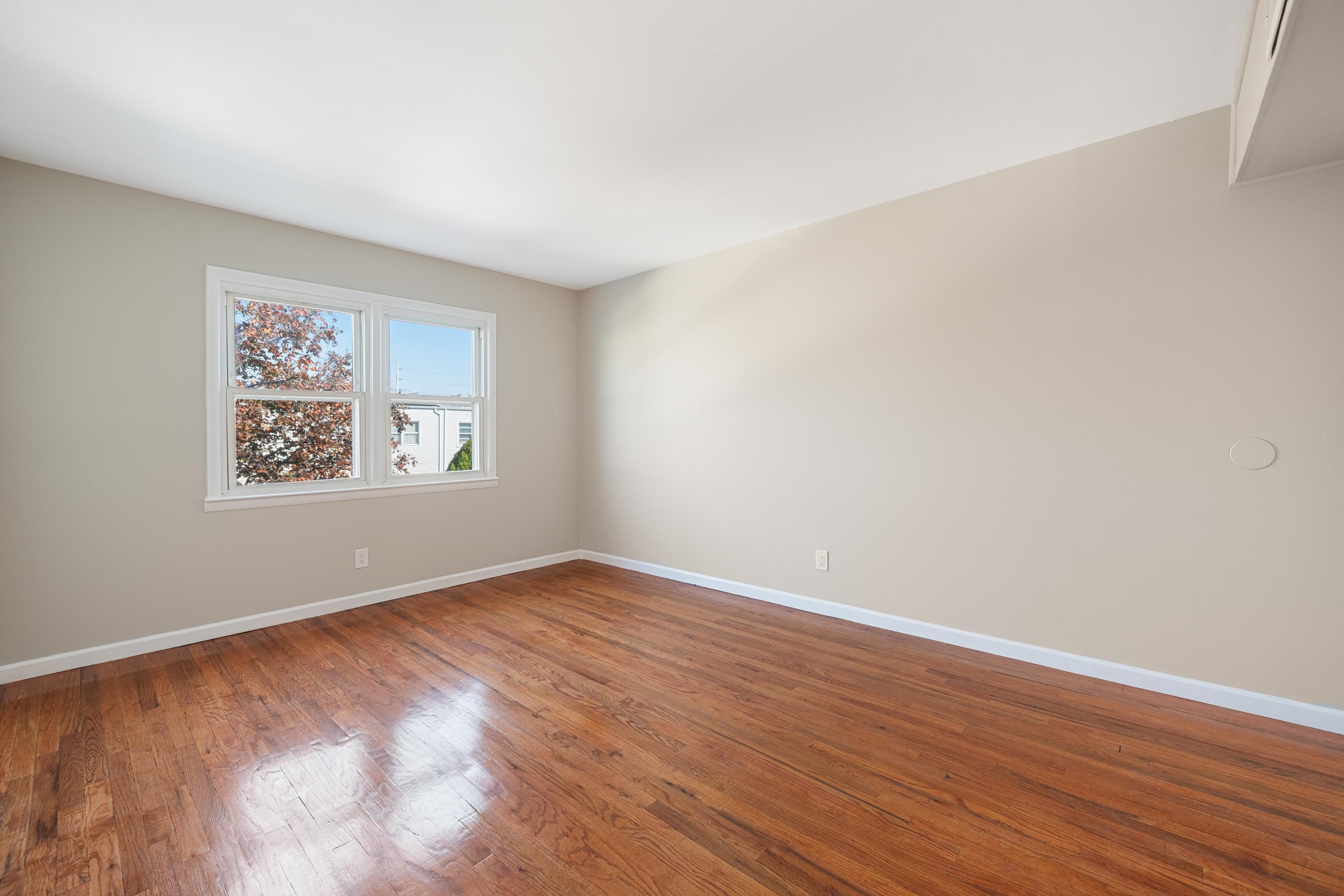 14 Delmar Road Jersey City, NJ 07305 - Photo 28 of 38 an empty room with wooden floor and windows
