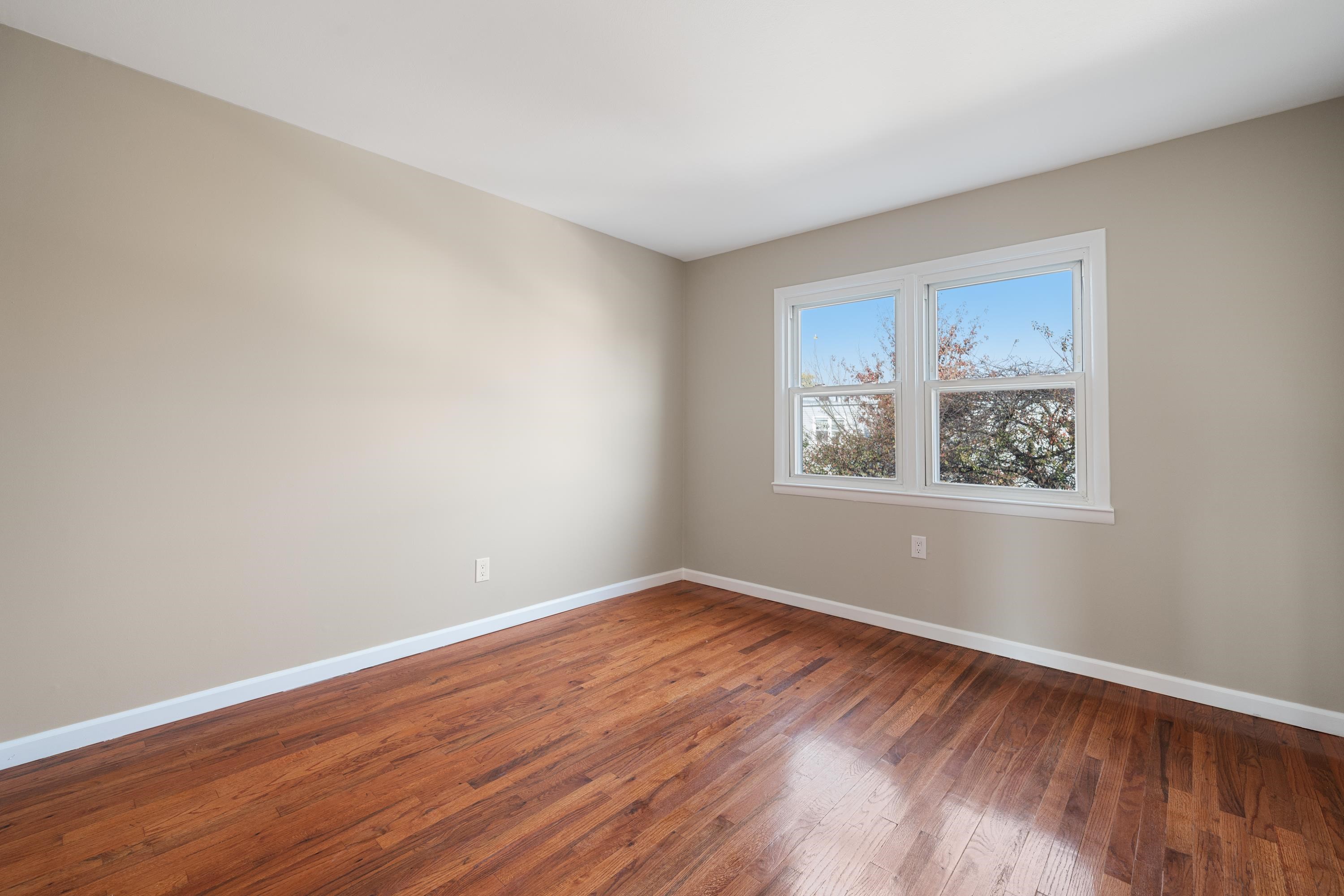 14 Delmar Road Jersey City, NJ 07305 - Photo 31 of 38 a view of an empty room with wooden floor and a window