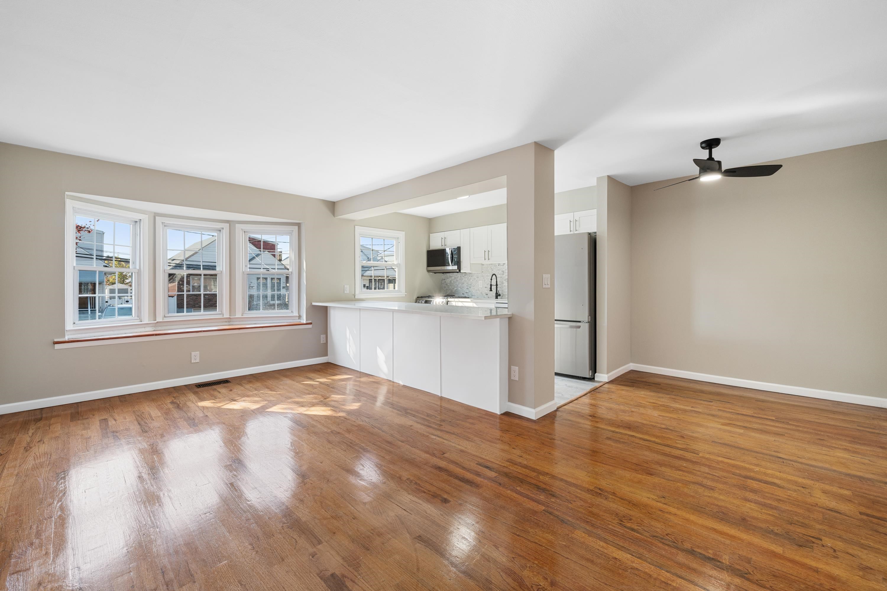 14 Delmar Road Jersey City, NJ 07305 - Photo 4 of 38 a view of an empty room with window and wooden floor