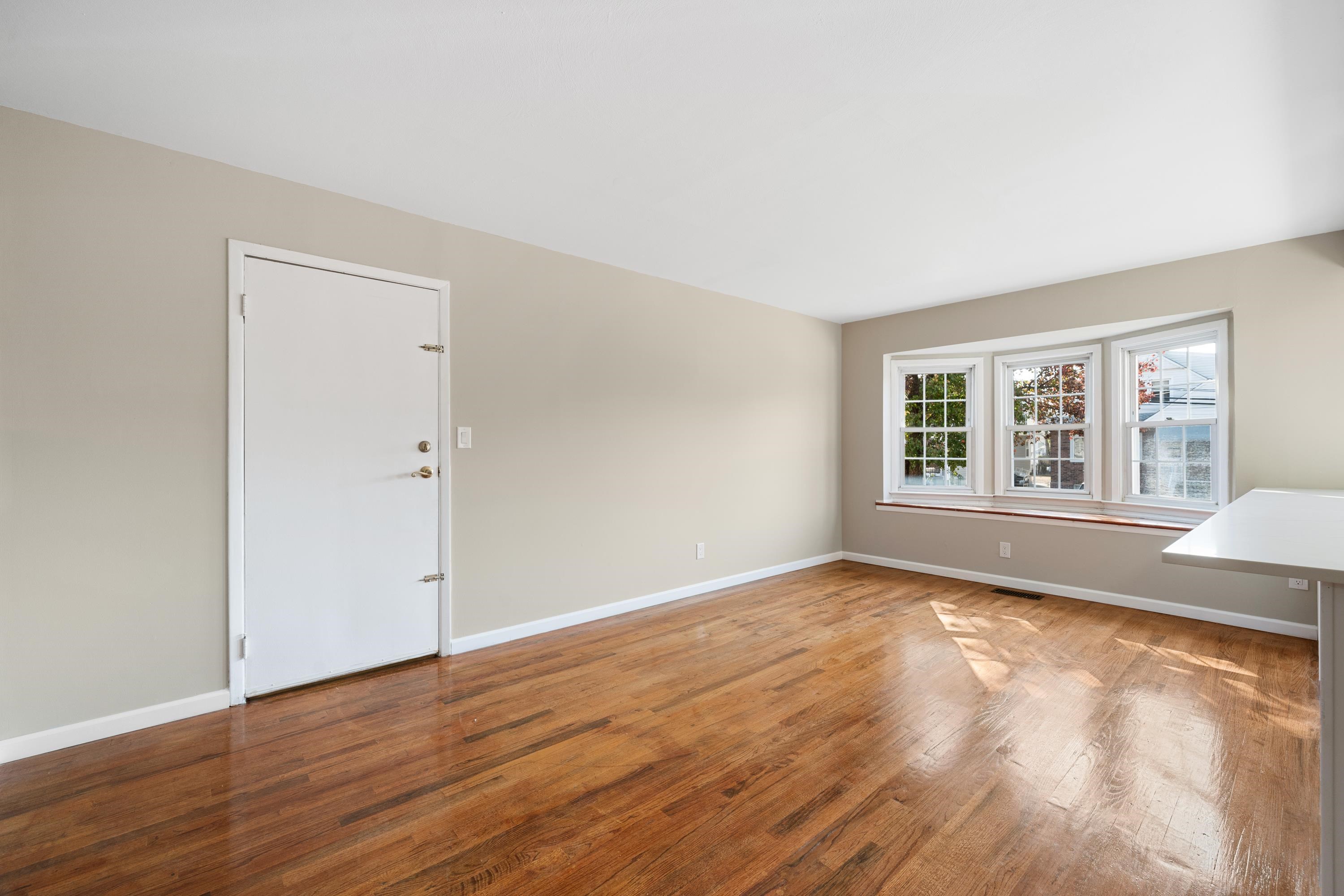 14 Delmar Road Jersey City, NJ 07305 - Photo 6 of 38 a view of an empty room with wooden floor and a window