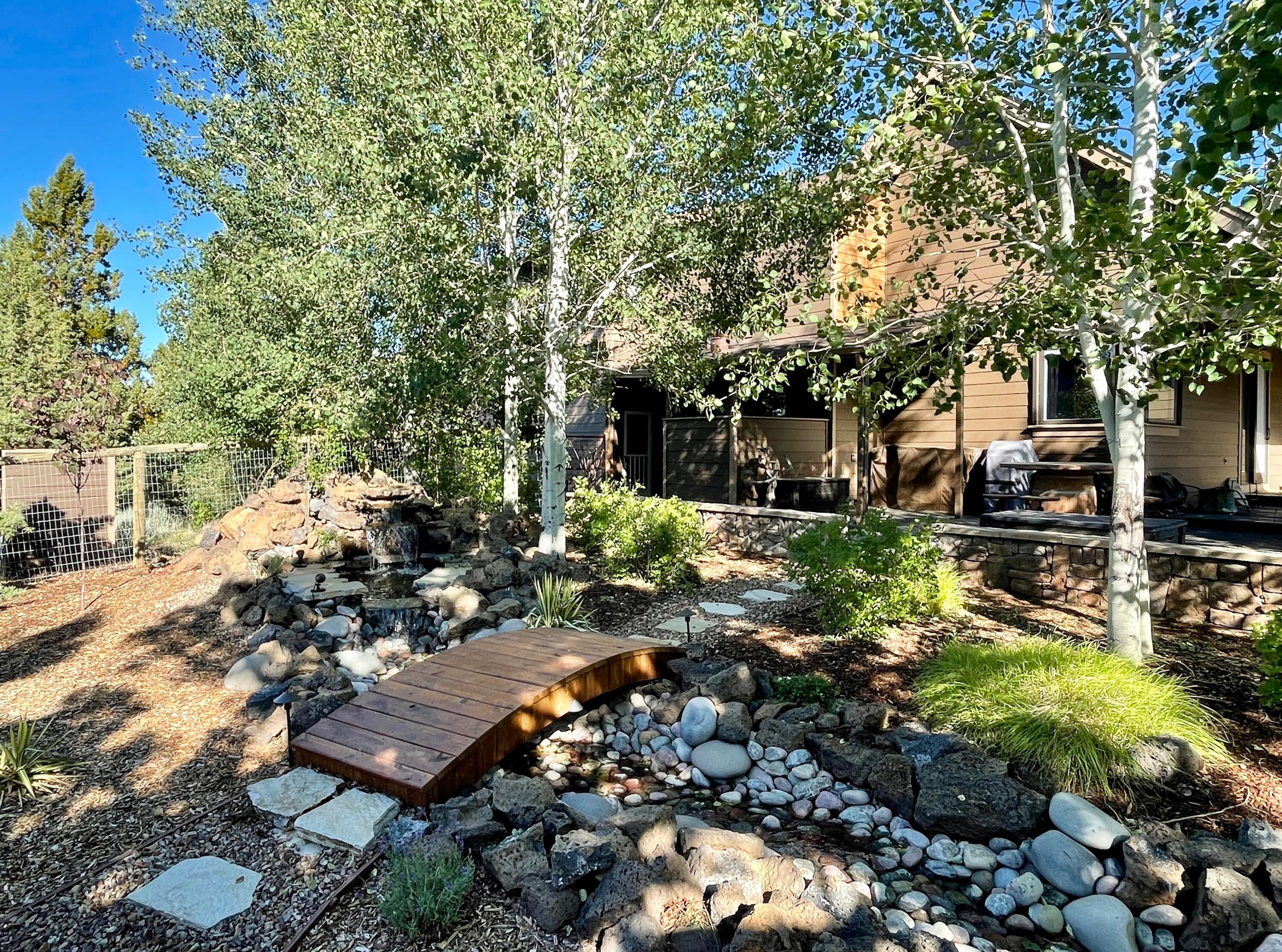 63545 Overtree Road Bend, OR 97701 - Photo 46 of 63 newly built water feature, bridge leads to private patio