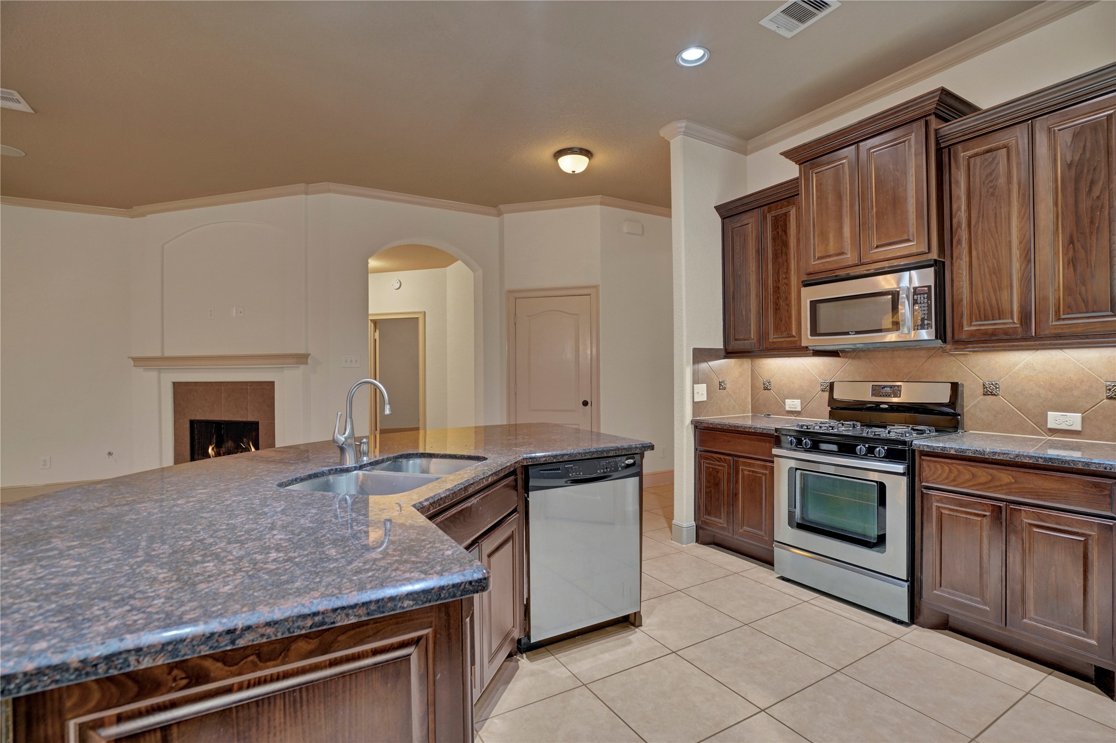 10 Tallgrass Way Spring, TX 77389 - Photo 11 of 23 a kitchen with granite countertop a stove sink and cabinets