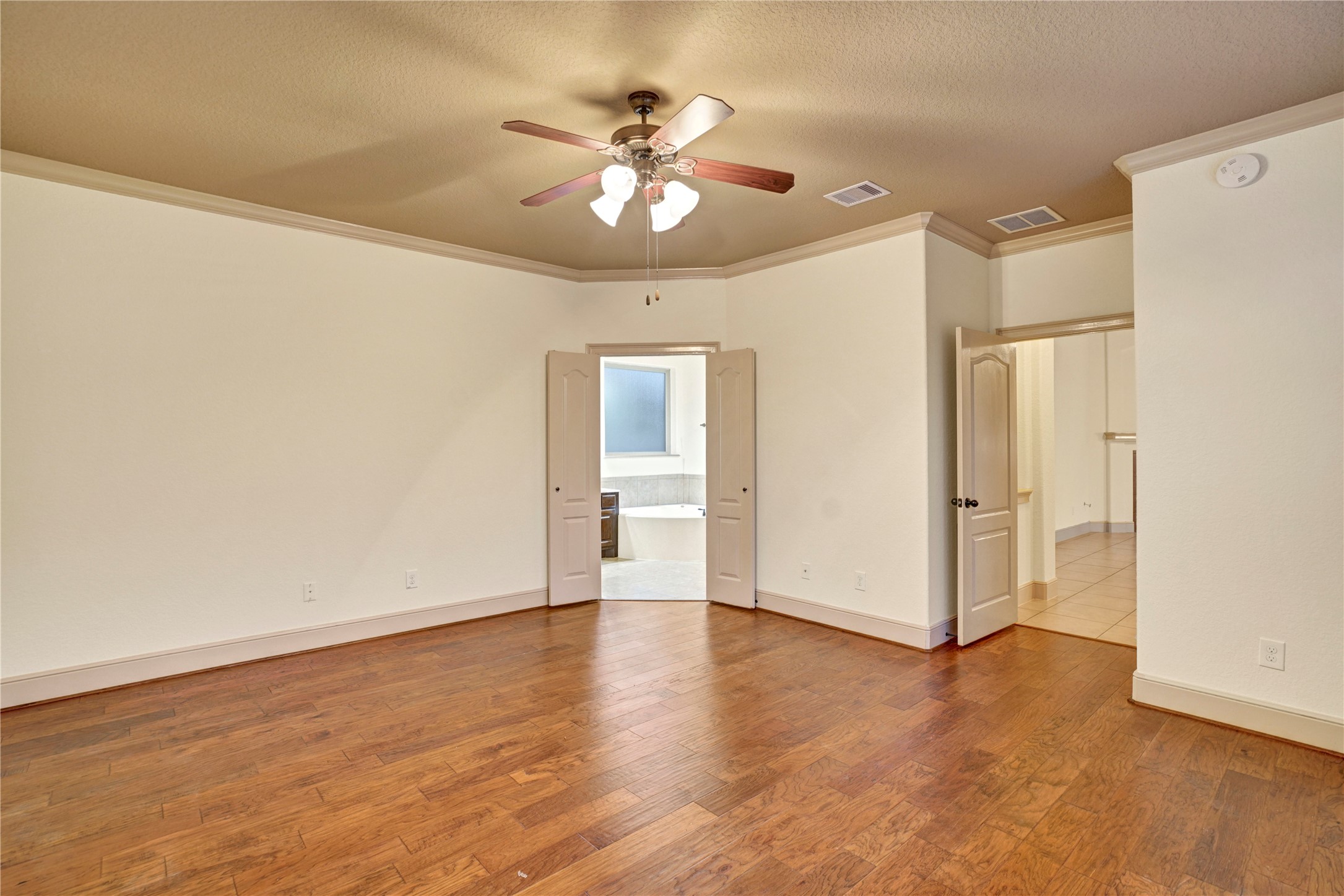 10 Tallgrass Way Spring, TX 77389 - Photo 13 of 23 a view of an empty room with glass door and a ceiling fan
