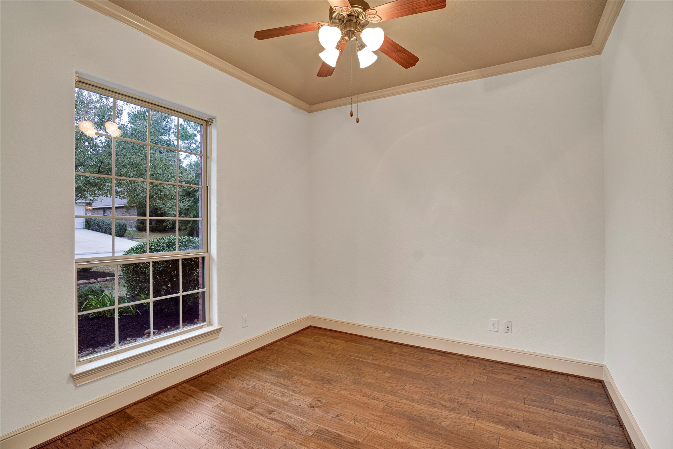10 Tallgrass Way Spring, TX 77389 - Photo 20 of 23 an empty room with wooden floor and windows