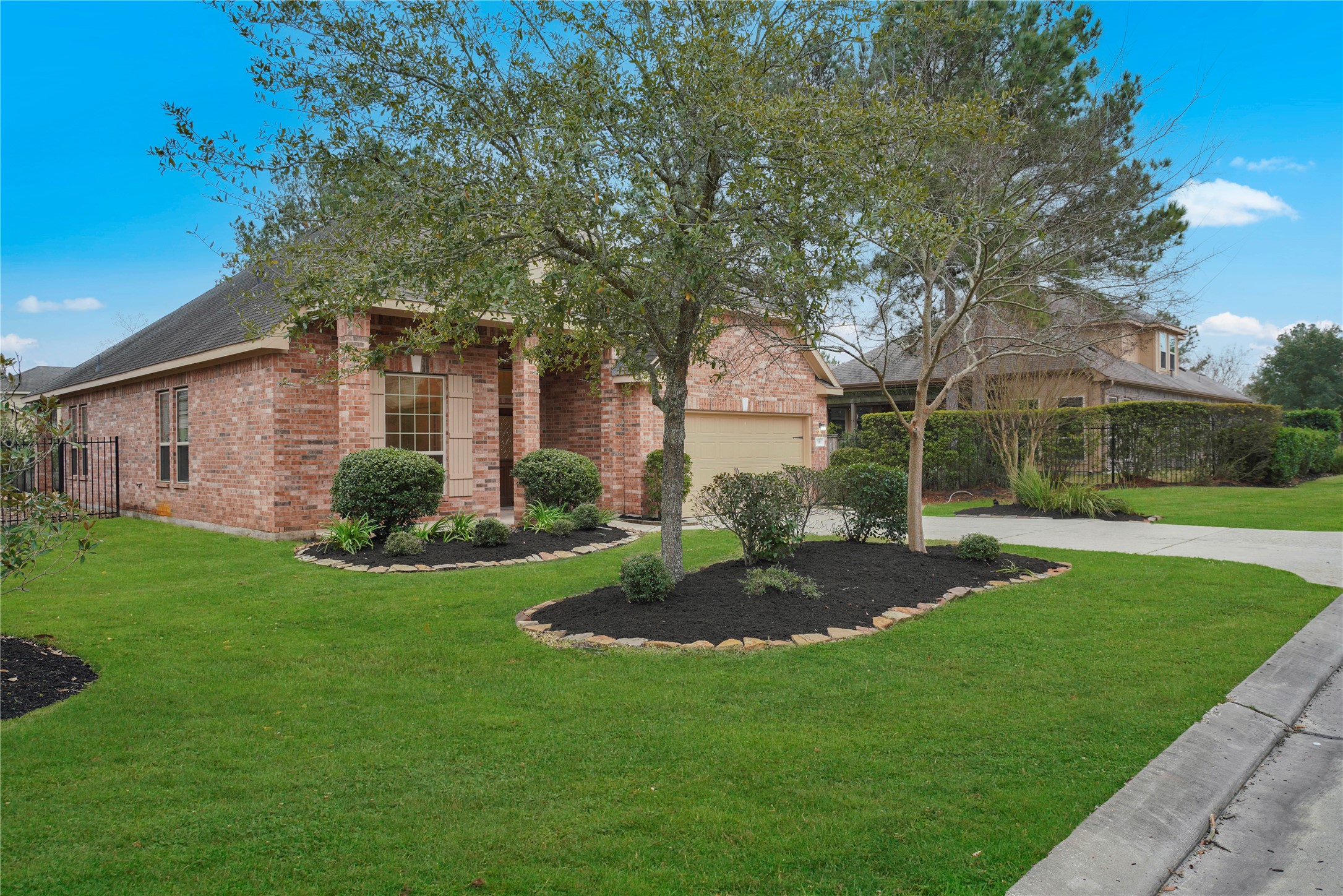 10 Tallgrass Way Spring, TX 77389 - Photo 3 of 23 a view of a big yard with plants and large trees