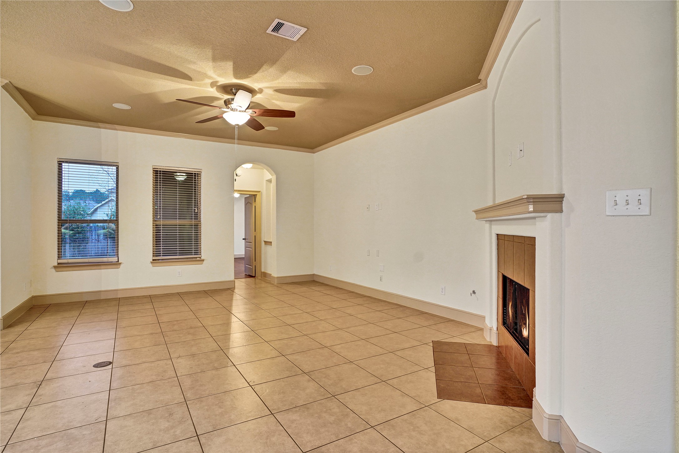 10 Tallgrass Way Spring, TX 77389 - Photo 7 of 23 a view of an empty room with chandelier fan and a window