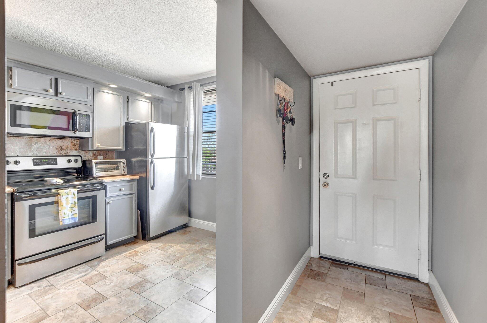 6025 Balboa Circle, Unit 303 Boca Raton, FL 33433 - Photo 3 of 23 a kitchen with a refrigerator sink and stove top oven