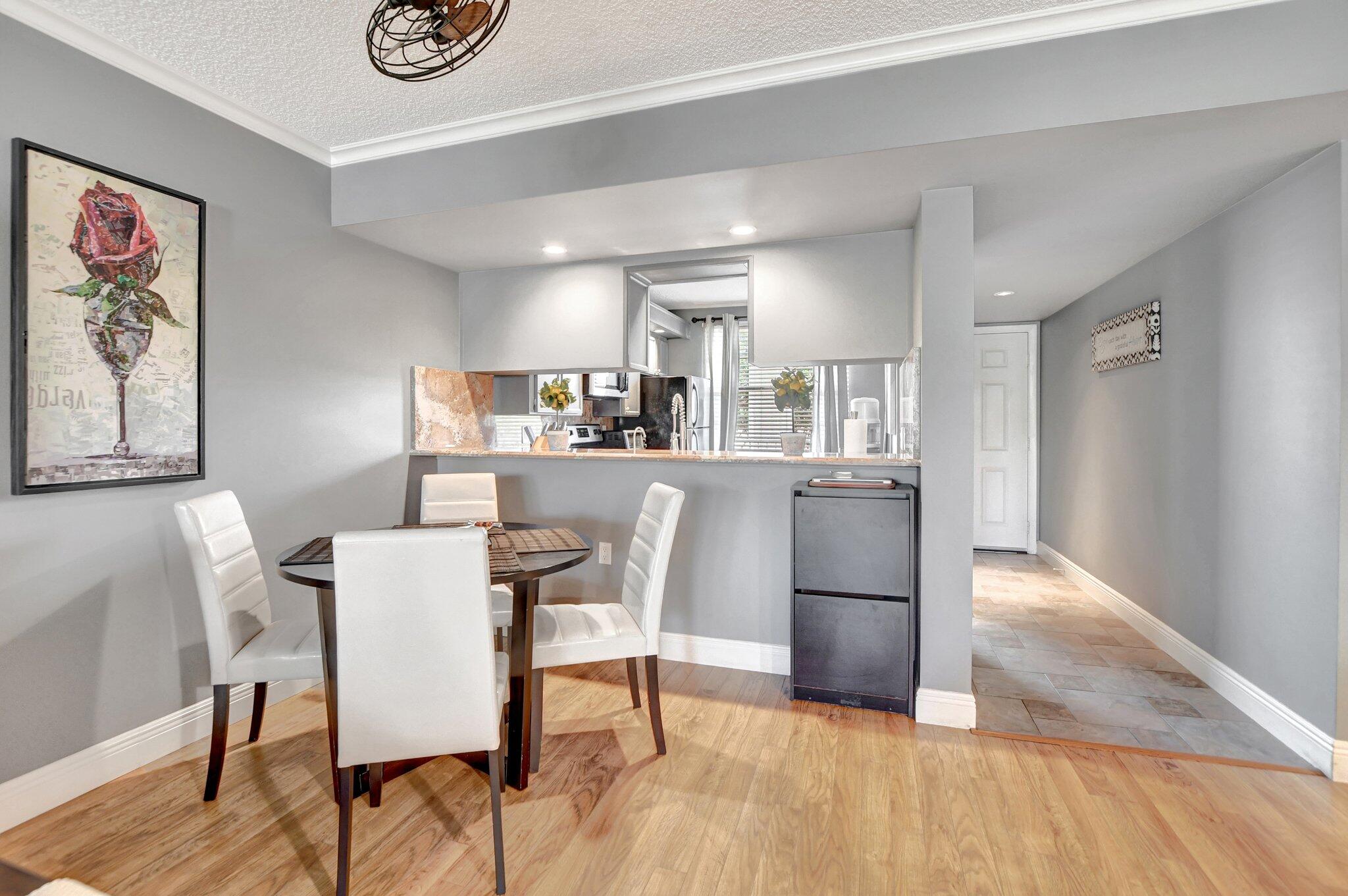 6025 Balboa Circle, Unit 303 Boca Raton, FL 33433 - Photo 6 of 23 a kitchen with a table and chairs in it
