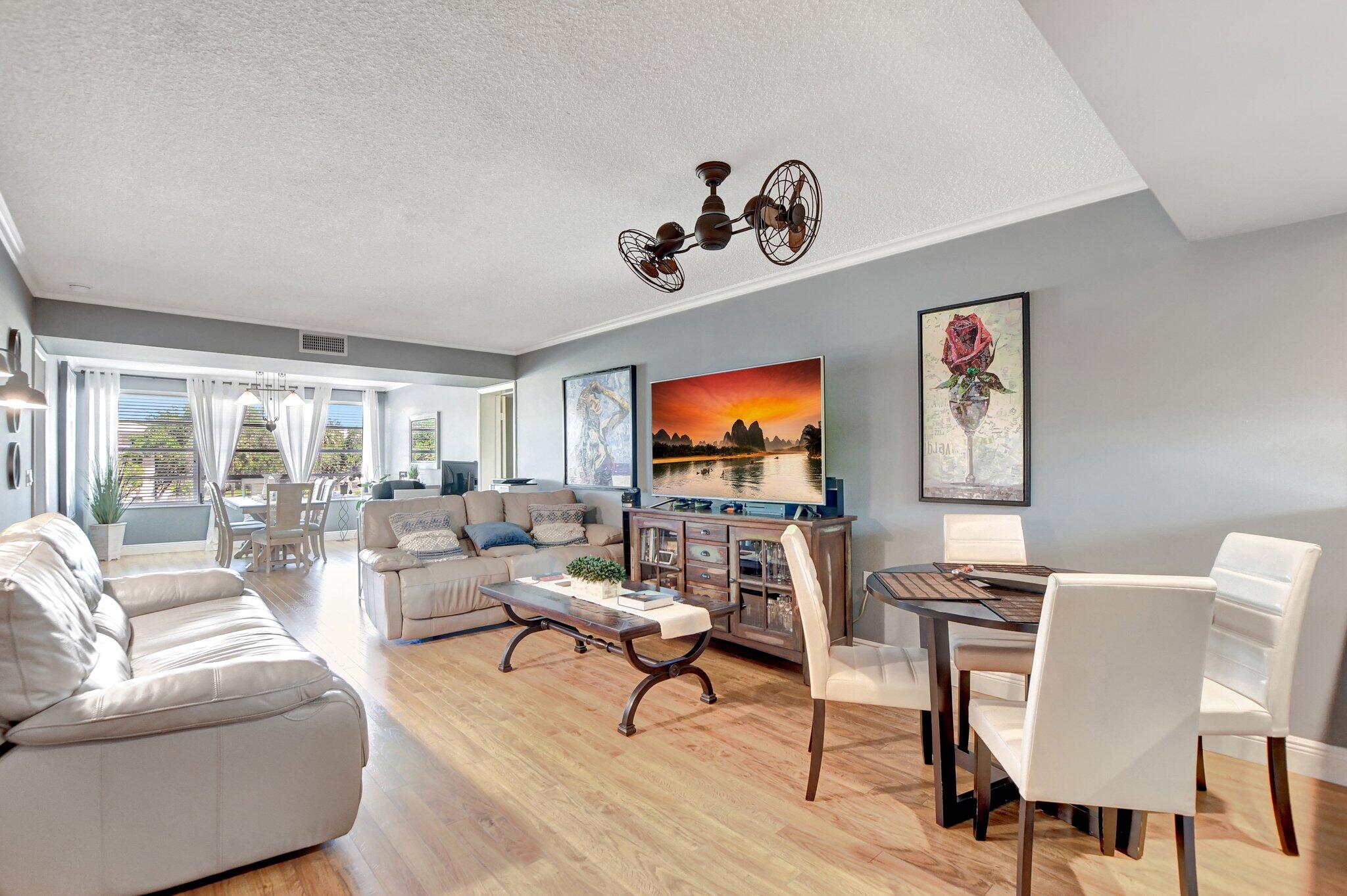6025 Balboa Circle, Unit 303 Boca Raton, FL 33433 - Photo 7 of 23 a living room with furniture and a flat screen tv