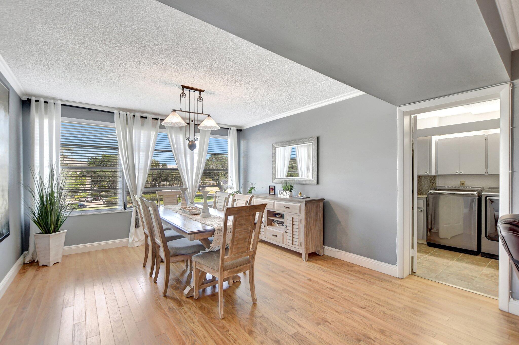 6025 Balboa Circle, Unit 303 Boca Raton, FL 33433 - Photo 8 of 23 a view of a dining room with furniture window and wooden floor