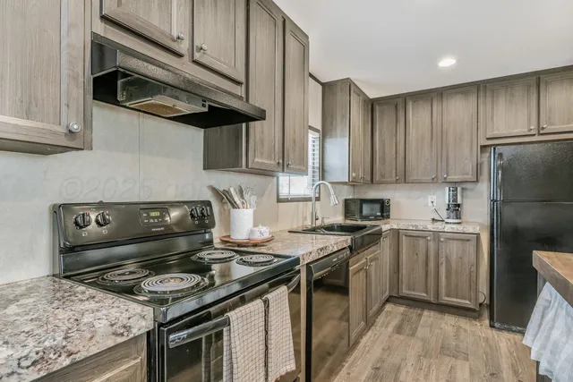 a kitchen with a stove and a refrigerator