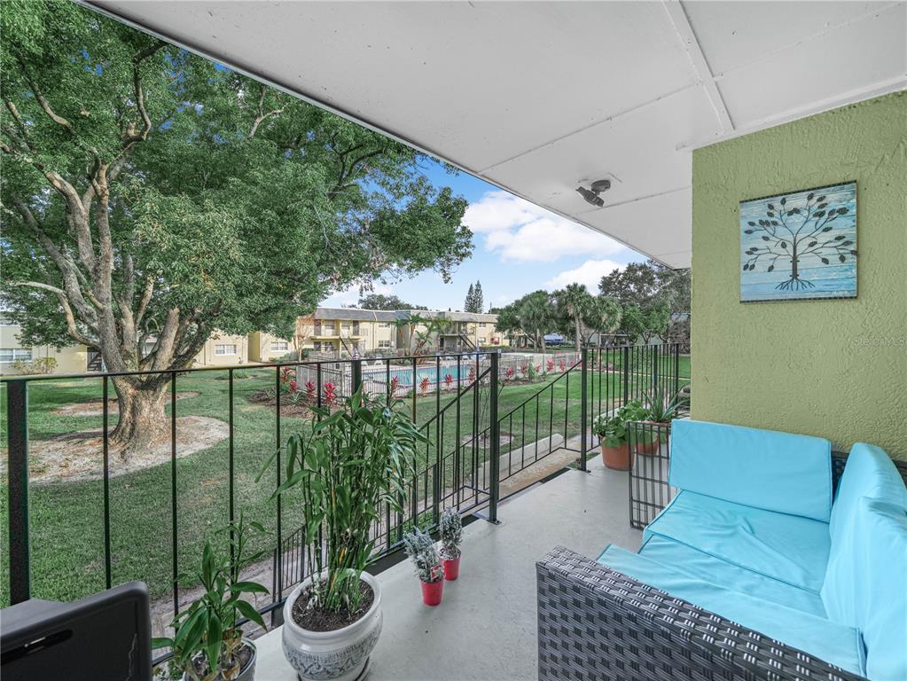 525 South Conway Road, Unit 100 Orlando, FL 32807 - Photo 3 of 23 a outdoor living space with furniture and garden view