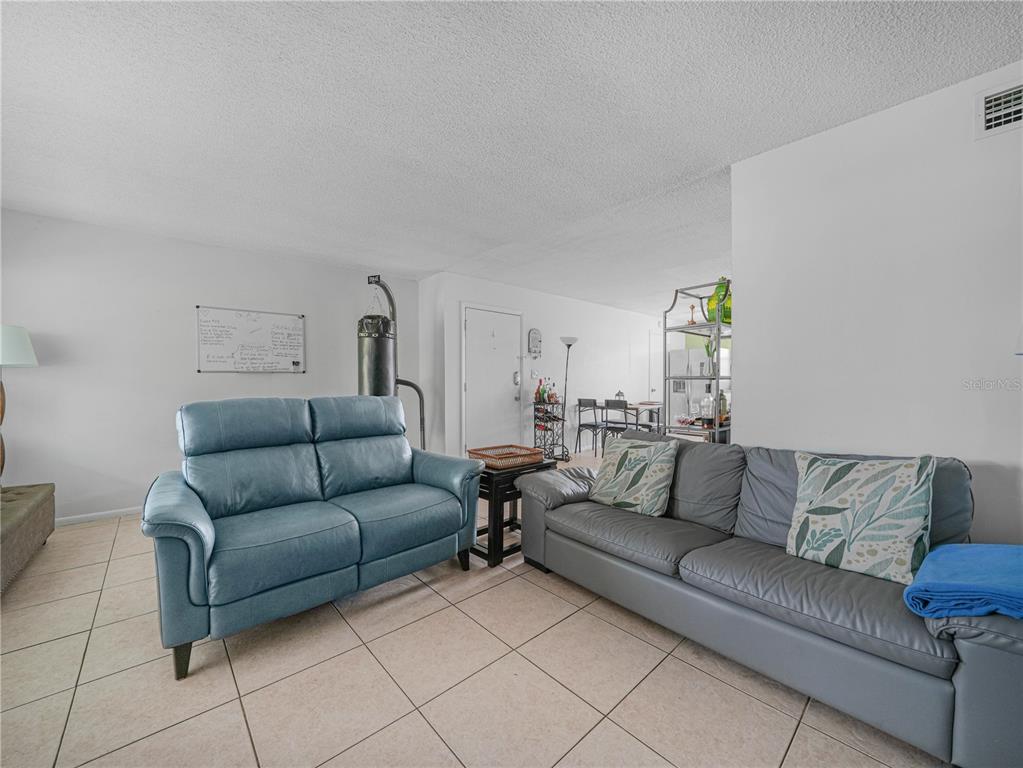 525 South Conway Road, Unit 100 Orlando, FL 32807 - Photo 5 of 23 a living room with furniture and a couch