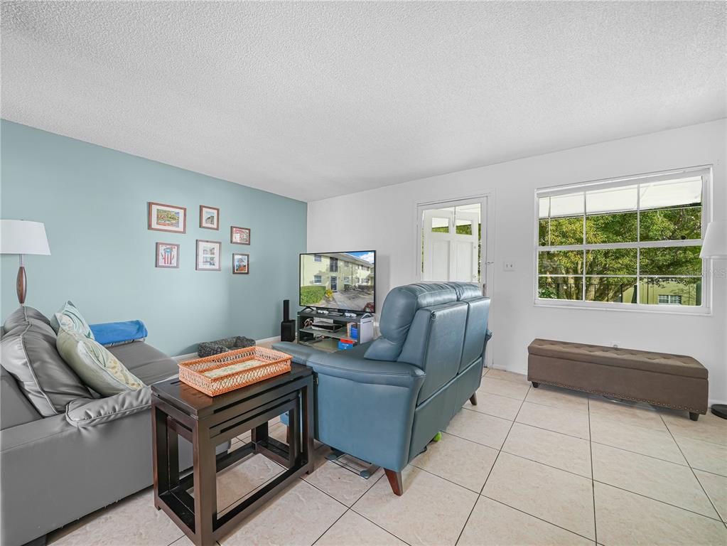525 South Conway Road, Unit 100 Orlando, FL 32807 - Photo 6 of 23 a living room with furniture and a window