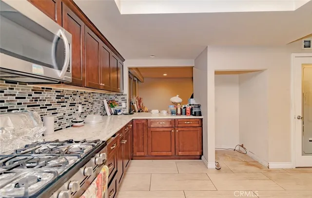 a kitchen with stainless steel appliances granite countertop a stove and a sink