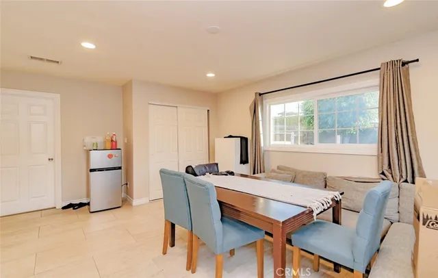 a dining room with furniture and window
