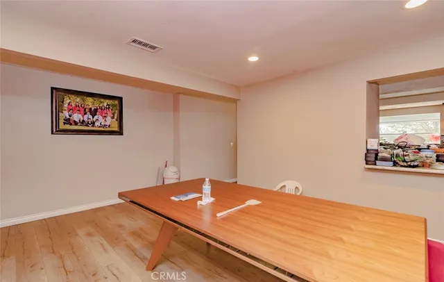 a bedroom with a bed and painting on the wall