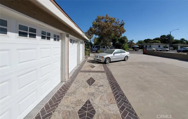 a couple of cars parked in front of a house