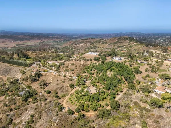 an aerial view of houses with trees