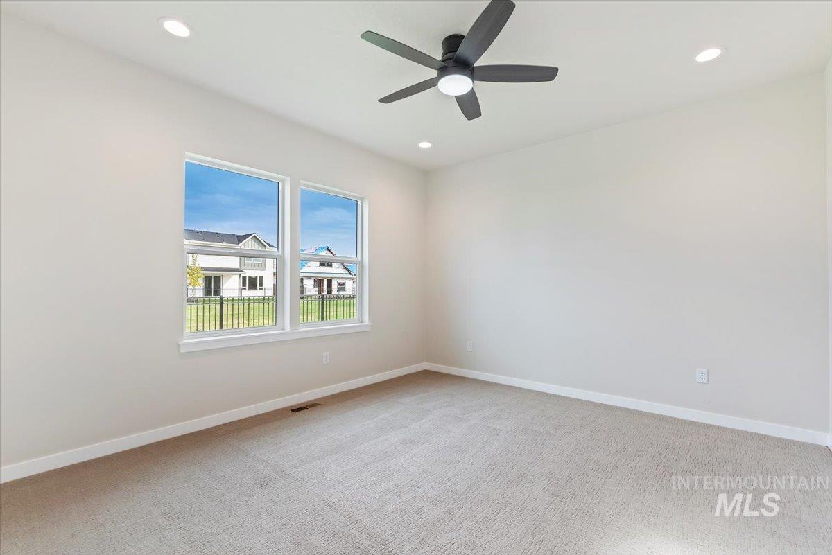 3866 West Spring House Lane Eagle, ID 83616 - Photo 15 of 33 Empty room with light carpet, recessed lighting, and ceiling fan
