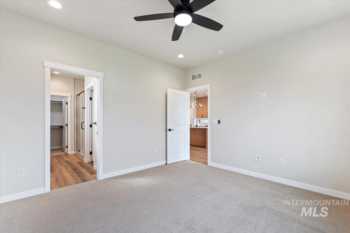 3866 West Spring House Lane Eagle, ID 83616 - Photo 16 of 33 Unfurnished bedroom featuring a spacious closet, light carpet, recessed lighting, and a ceiling fan