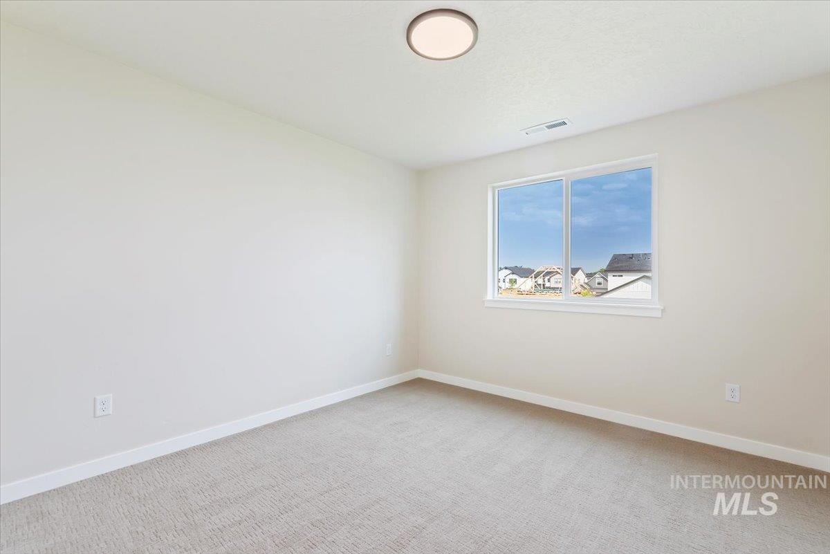 3866 West Spring House Lane Eagle, ID 83616 - Photo 19 of 33 Empty room with light colored carpet and baseboards
