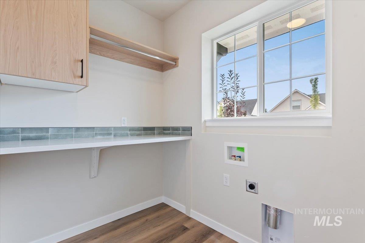 3866 West Spring House Lane Eagle, ID 83616 - Photo 26 of 33 Washroom featuring cabinet space, dark wood-type flooring, washer hookup, and electric dryer hookup
