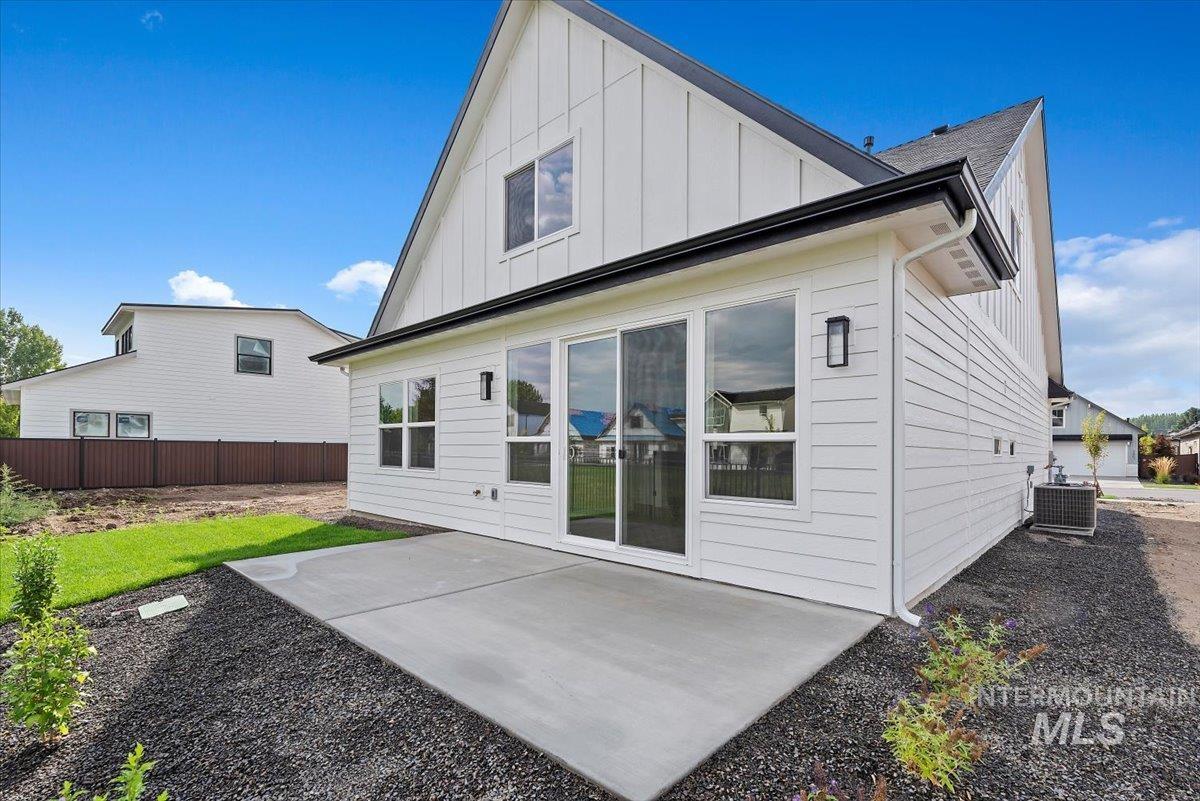 3866 West Spring House Lane Eagle, ID 83616 - Photo 30 of 33 Back of house featuring board and batten siding and a patio