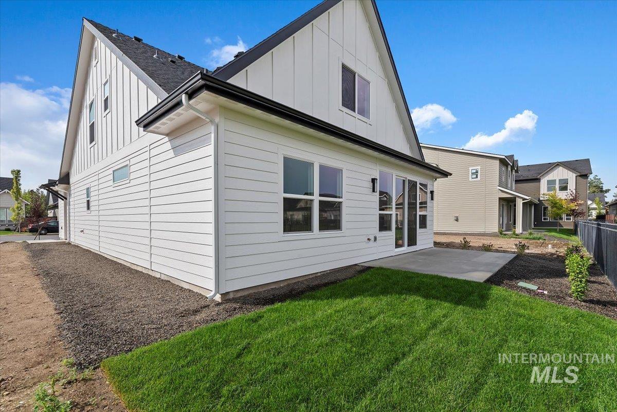 3866 West Spring House Lane Eagle, ID 83616 - Photo 31 of 33 Back of house with board and batten siding and a patio area