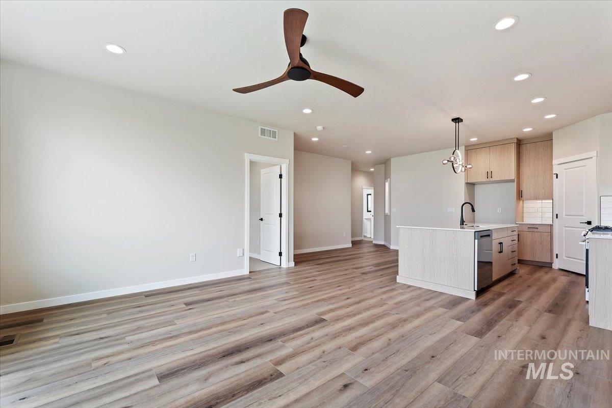 3866 West Spring House Lane Eagle, ID 83616 - Photo 5 of 33 Unfurnished living room featuring light wood-style flooring, recessed lighting, and a ceiling fan