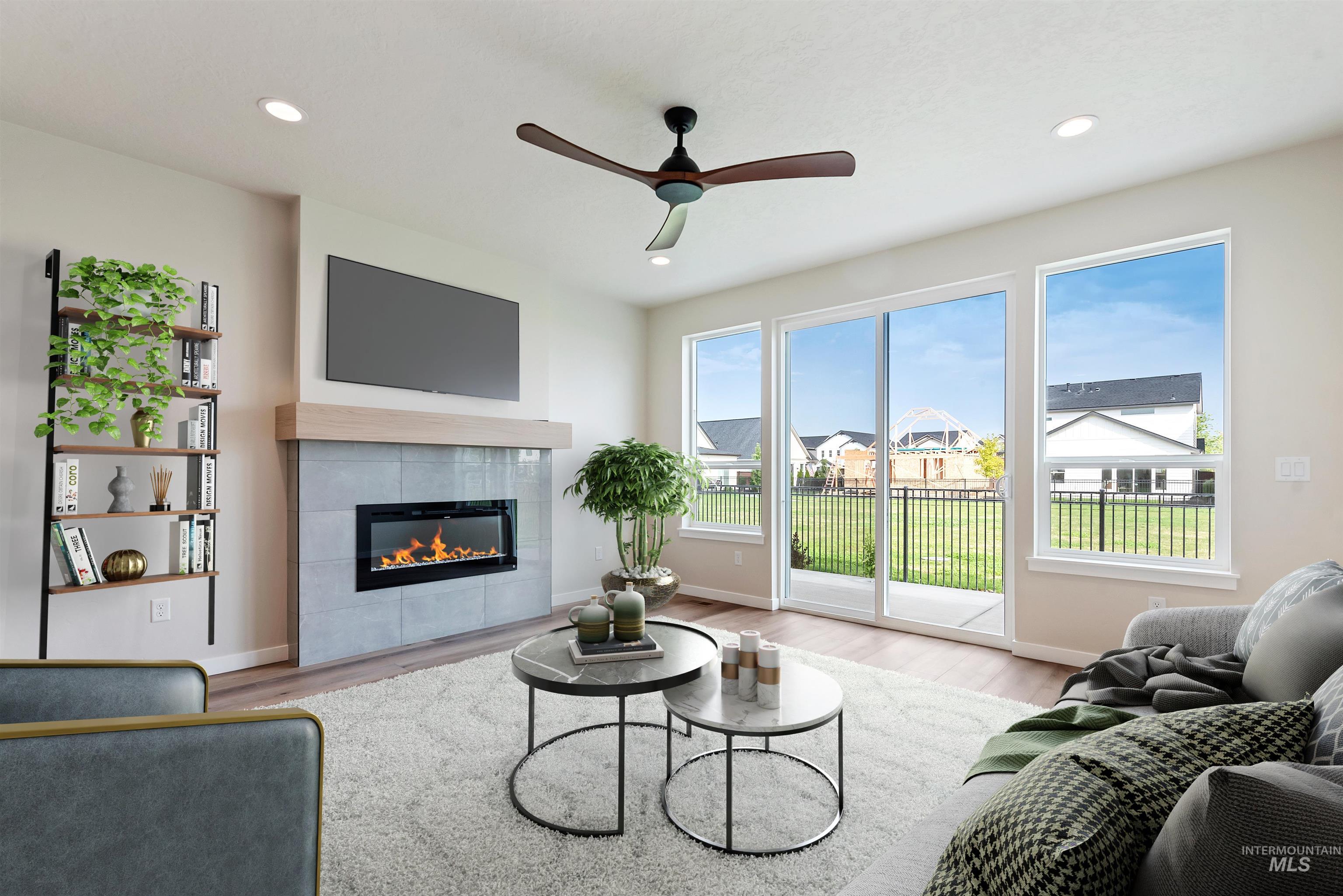 3866 West Spring House Lane Eagle, ID 83616 - Photo 6 of 33 Living area with a ceiling fan, a fireplace, recessed lighting, wood finished floors, and a residential view