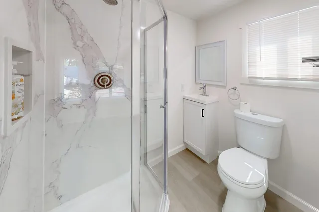 a bathroom with a toilet sink and shower