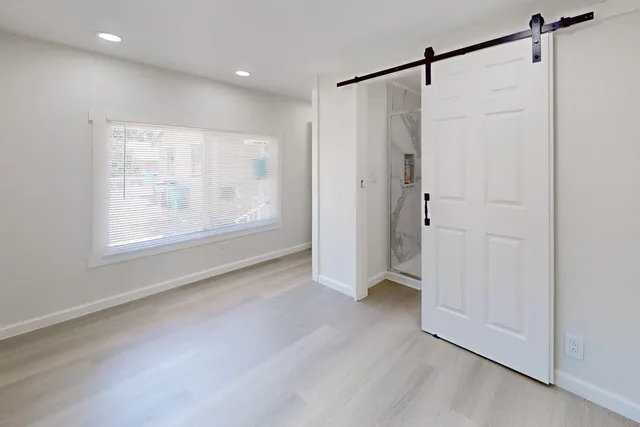 a view of an empty room with a window